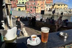 Barrie Jarrett having a beer at Genoa Italy beach cove little quaint pub