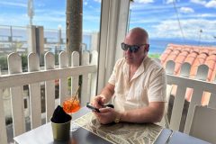 Mark Stafford with Aperol spritz on table with nibbles